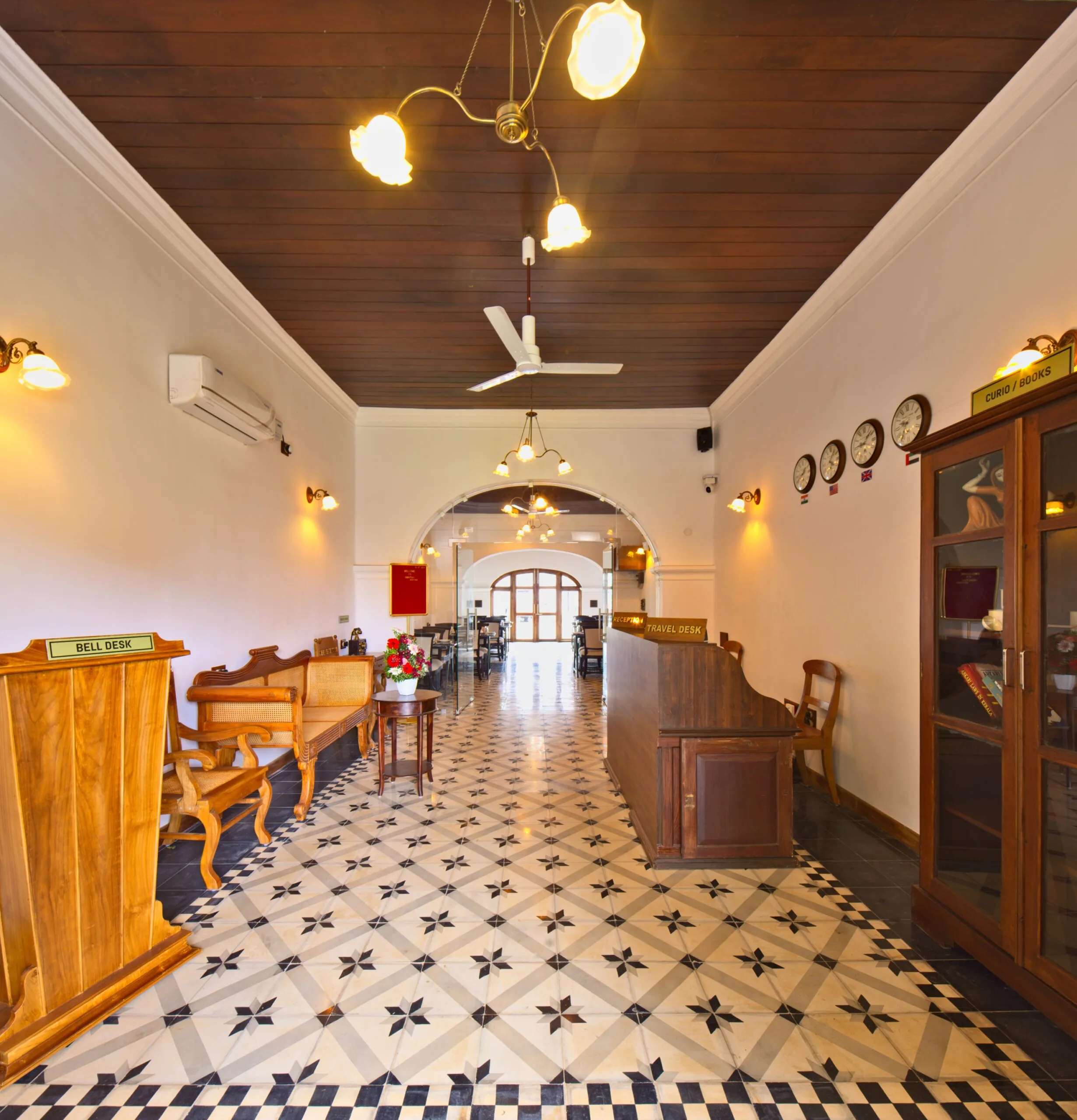 The heritage entrance hall with its bell desk, cane seating and chequered floor.